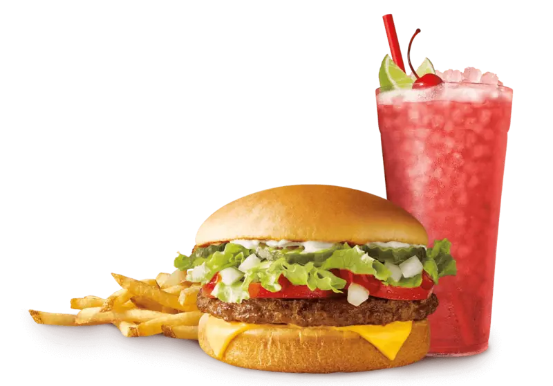 Cheeseburger with lettuce and tomato, a side of fries, and a cold red beverage with a cherry garnish at a drive-in restaurant franchise.